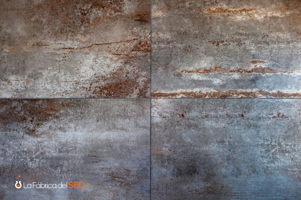 Gres porcelánico efecto metal oxidado con tonos grises y marrones en formato gran formato para revestimiento